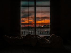 Photo of half open blinds showing a cold winter morning sunrise